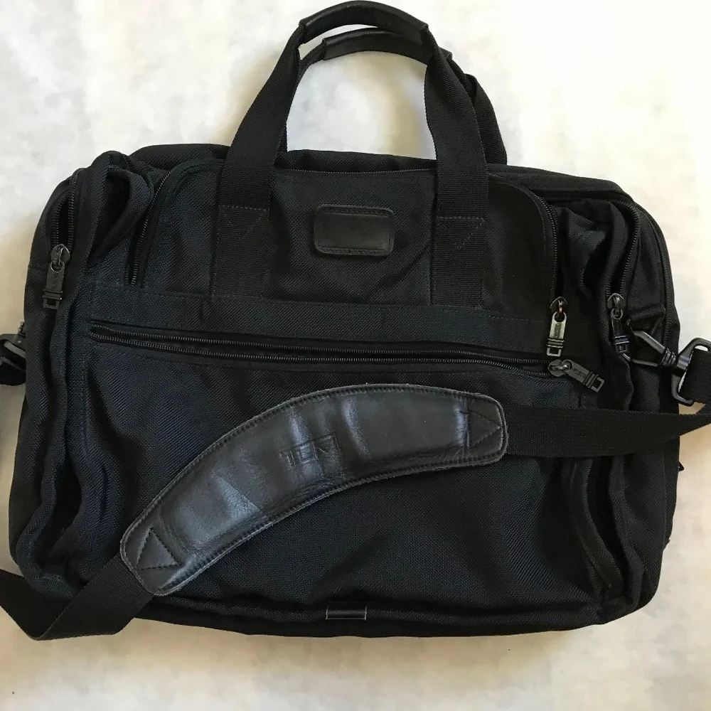 Tumi Black expandable laptop bag. clean interior. Work, travel, Classic